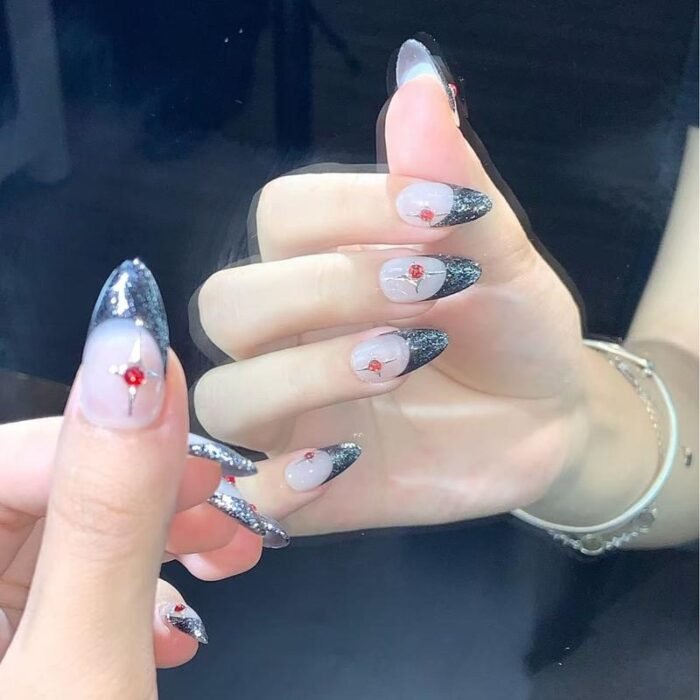 Lifestyle image of model wearing grey and black glitter press-on nails