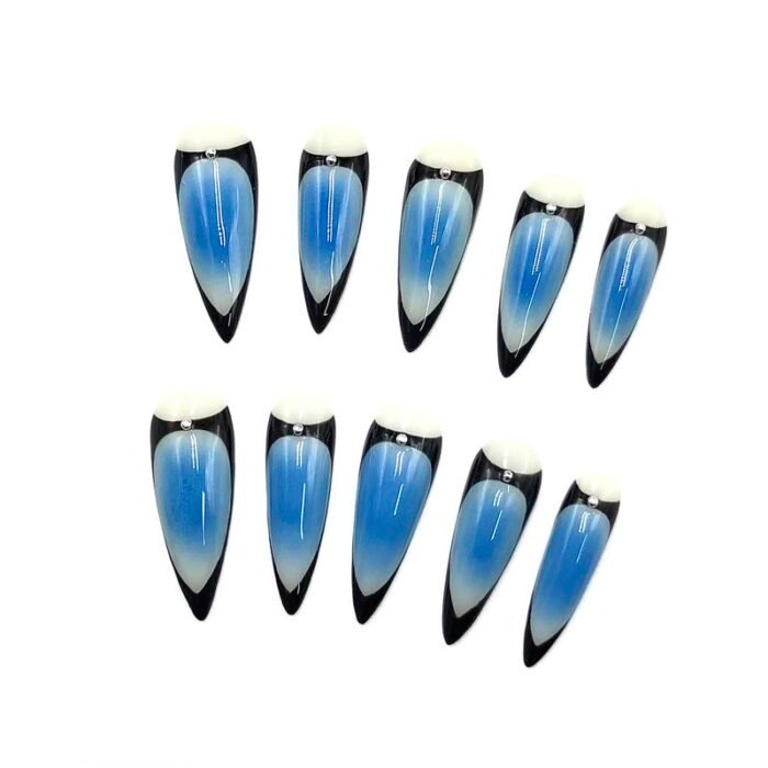 Close-up view of Lavara’s blue black stiletto press-on nails with metal stud embellishments